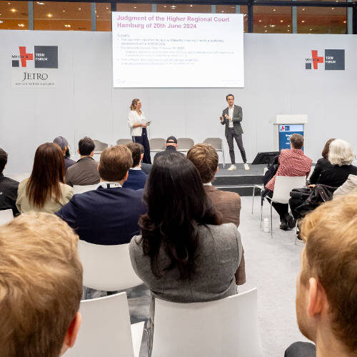 Audience seated in front of a stage at MEDICA