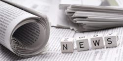 Photo: Four wooden cubes with letters on them form the word "news"